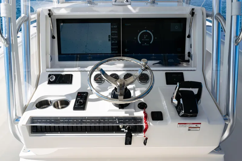 Slide: The Image of 2024 SeaVee 390B boat dashboard with steering wheel and navigation display. - 23