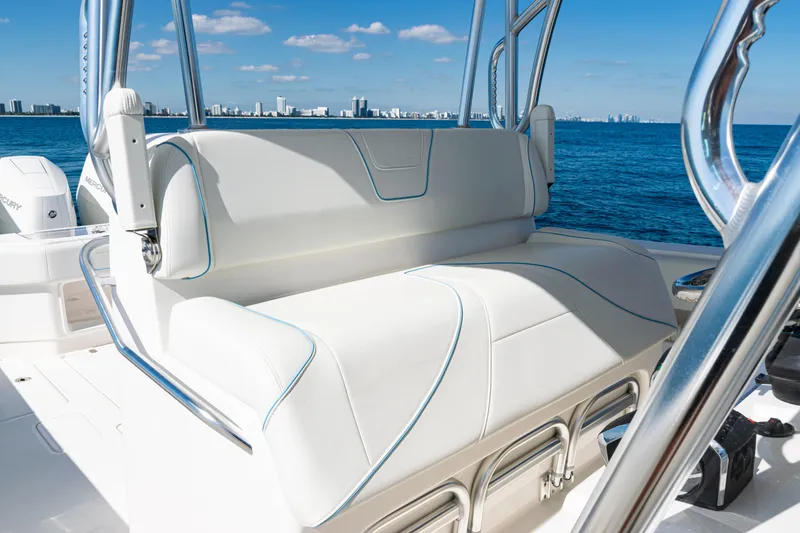 Slide: The Image of 2024 SeaVee 390B boat with luxurious seating, ocean view, and city skyline in the background. - 31