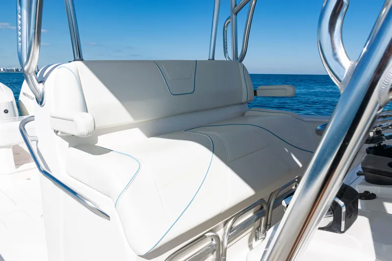 Slide: The Image of 2024 SeaVee 390B boat with white seating and ocean backdrop. - 32