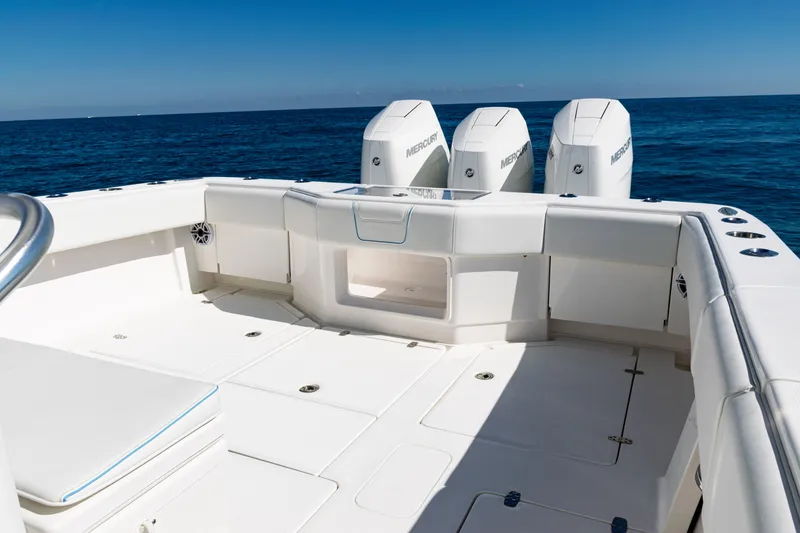 Slide: The Image of 2024 SeaVee 390B boat deck with triple Mercury engines on open sea. - 34