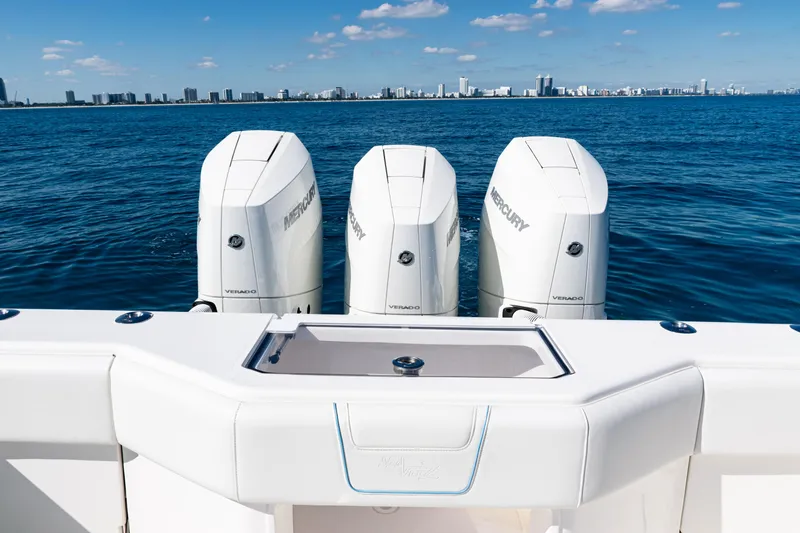 Slide: The Image of 2024 SeaVee 390B boat with triple Mercury Verado engines on open water. - 36