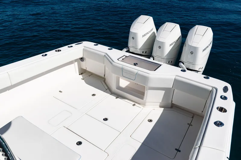 Slide: The Image of 2024 SeaVee 390B boat with triple Mercury outboard engines on open water. - 37