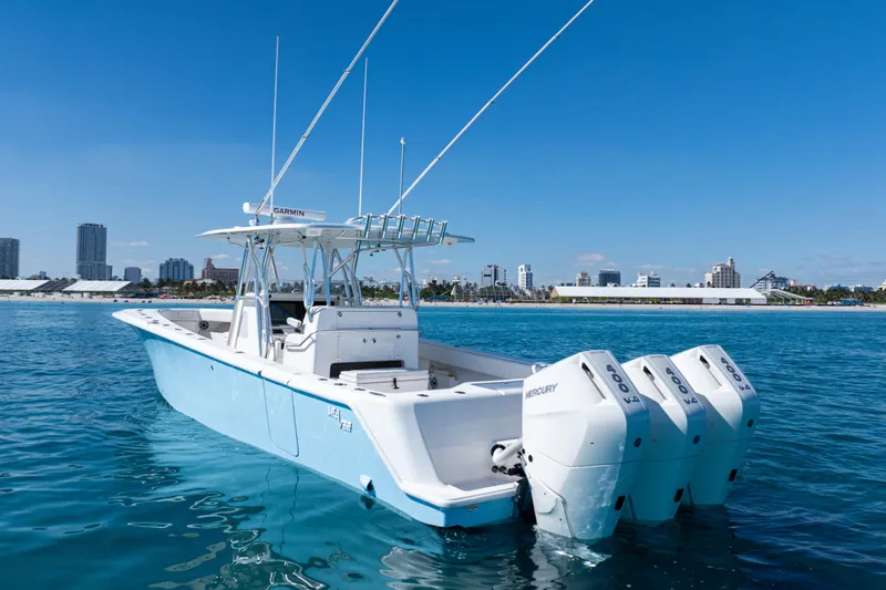 Slide: The Image of 2024 SeaVee 390B boat on clear blue water with city skyline in background. - 4