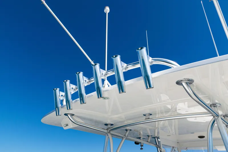 Slide: The Image of 2024 SeaVee 390B boat with rod holders against clear blue sky. - 51
