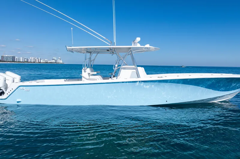 Slide: The Image of 2024 SeaVee 390B boat on calm ocean with city skyline in background. - 56