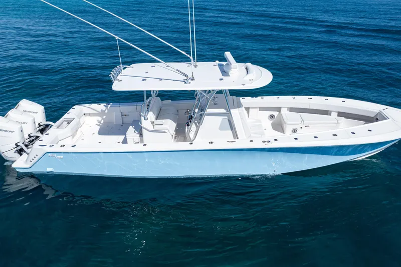 Slide: The Image of 2024 SeaVee 390B boat on clear blue water, featuring twin Mercury engines. - 57