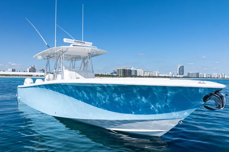 Slide: The Image of 2024 SeaVee 390B boat on calm water with city skyline background. - 6