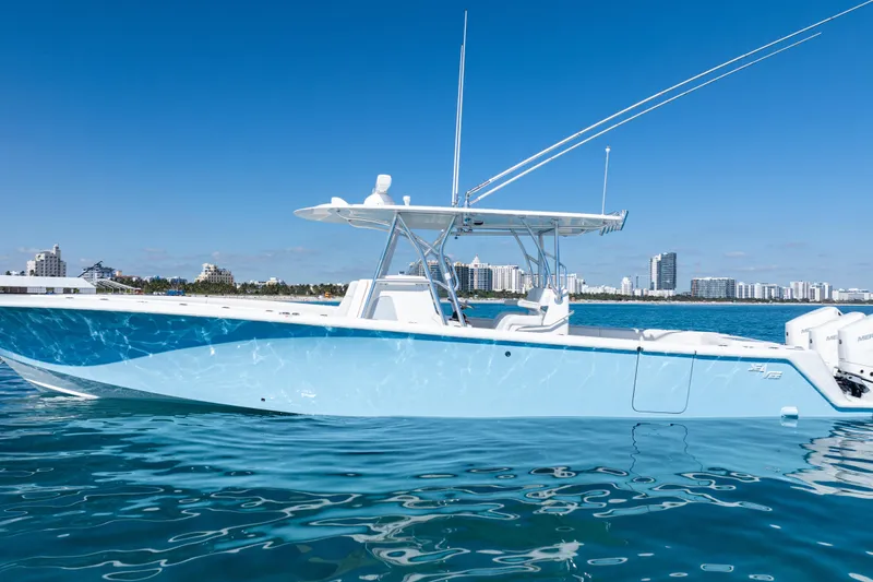 Slide: The Image of 2024 SeaVee 390B boat on calm water with city skyline in background. - 61