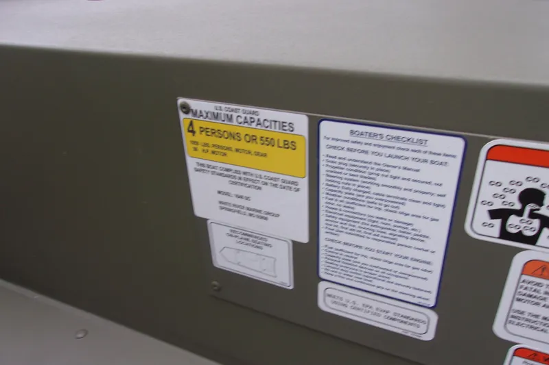 Slide: The Image of 2022 Tracker Grizzly 1648 MVX SC boat capacity and safety labels. - 11