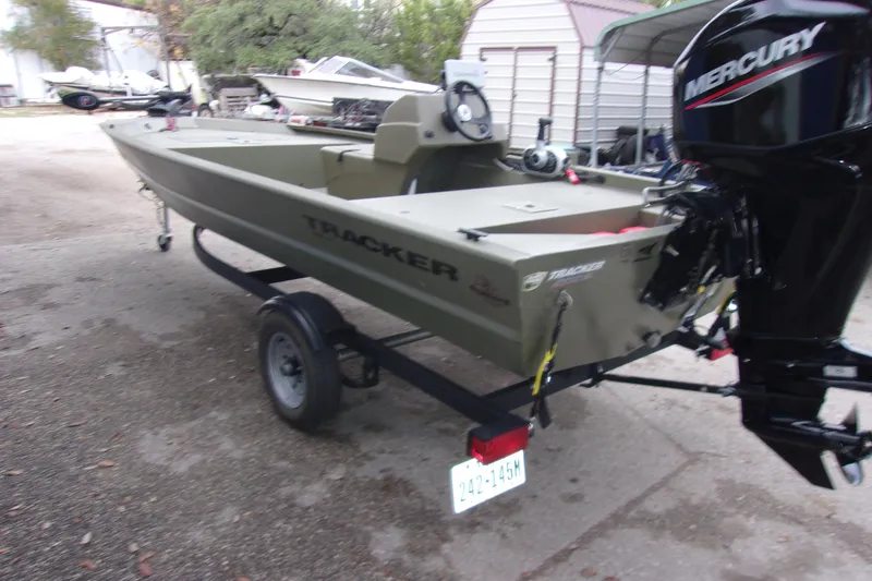 Slide: The Image of 2022 Tracker Grizzly 1648 MVX SC boat with Mercury engine on trailer. - 3