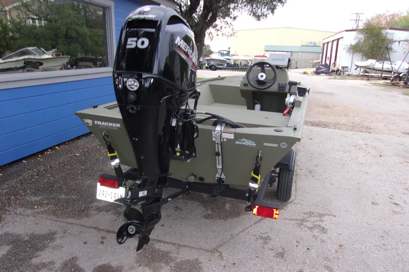 Slide: The Image of 2022 Tracker Grizzly 1648 MVX SC boat with Mercury 50 engine, parked outdoors. - 4