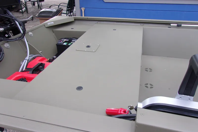 Slide: The Image of 2022 Tracker Grizzly 1648 MVX SC boat interior with storage and equipment. - 6