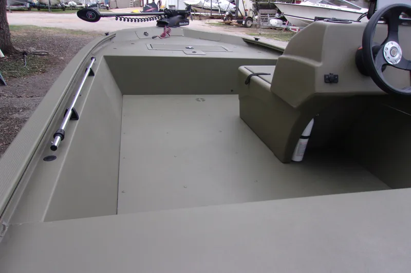 Slide: The Image of 2022 Tracker Grizzly 1648 MVX SC boat interior with steering console and spacious deck. - 7