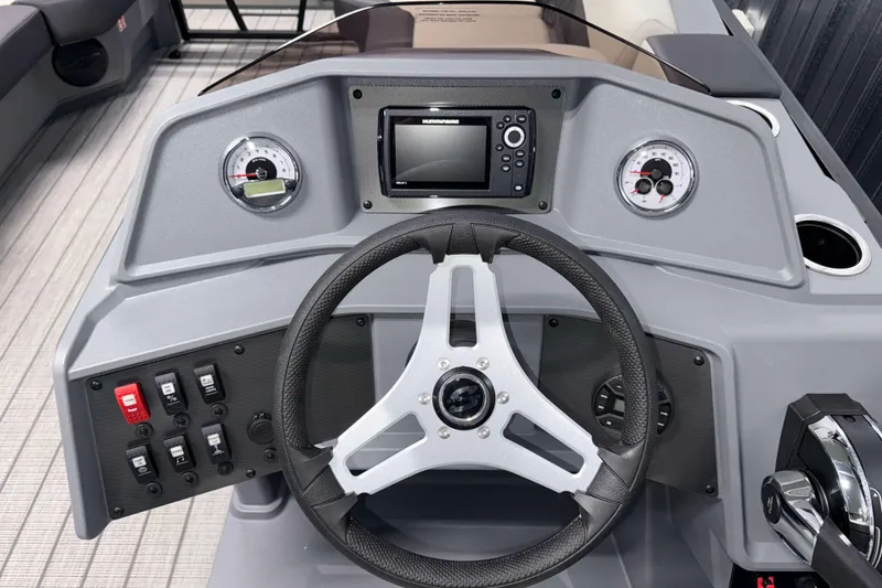 Slide: The Image of Steering console of 2026 Sylvan R-20 LZ DH boat with modern controls and gauges. - 10