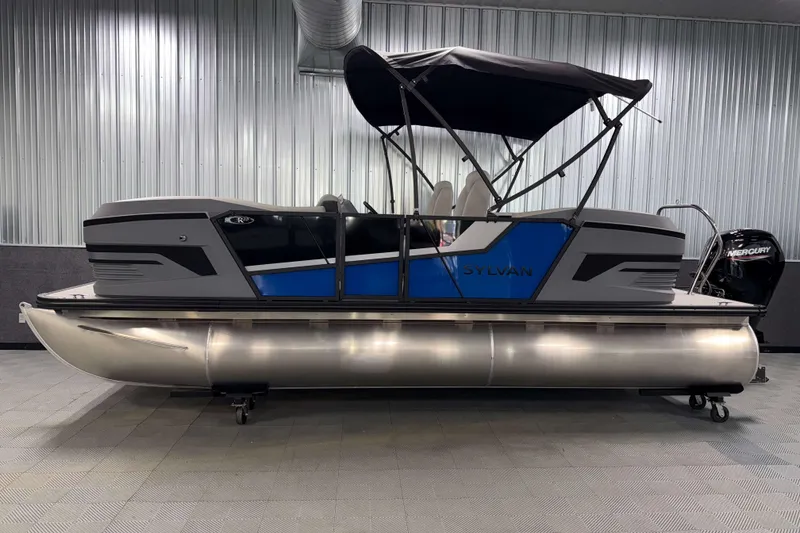 Slide: The Image of 2026 Sylvan R-20 LZ DH pontoon boat with canopy in a showroom. - 19