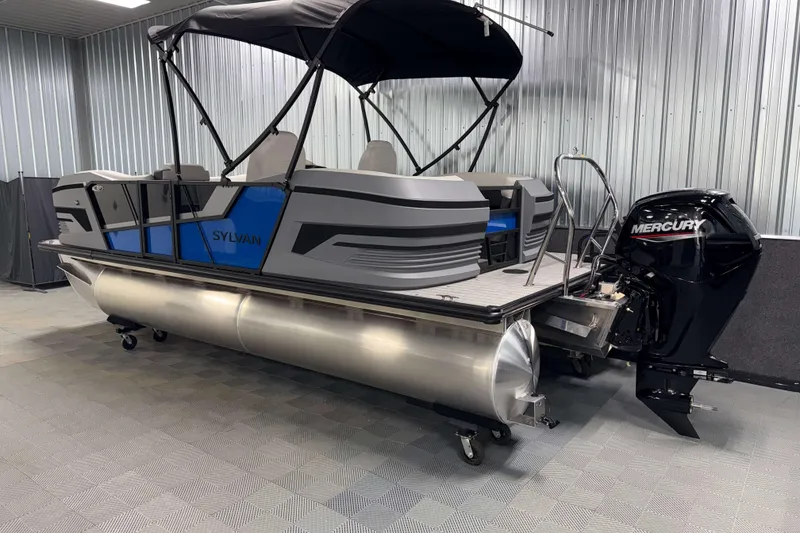 Slide: The Image of 2026 Sylvan R-20 LZ DH pontoon boat with Mercury outboard motor in a showroom. - 20