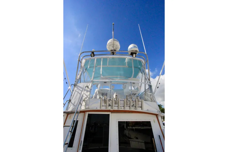 Slide: The Image of 1982 Bertram 35 Flybridge yacht with clear blue sky background. - 5