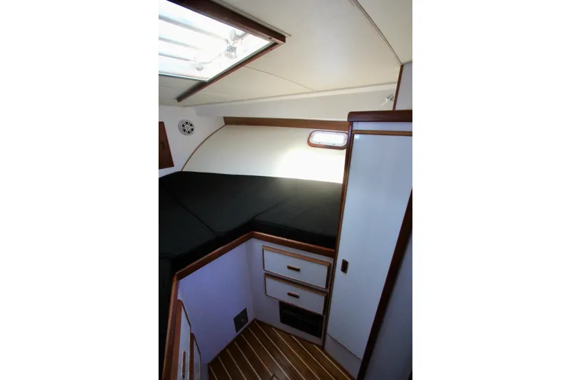 Slide: The Image of v berth stbd side with storage and hanging closet. - 24