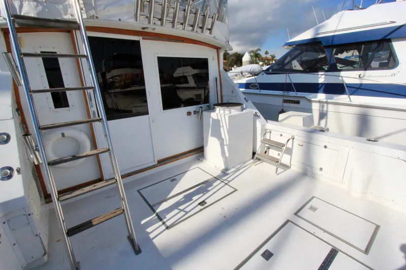 Slide: The Image of 1982 Bertram 35 Flybridge yacht deck with ladder and storage compartments. - 4