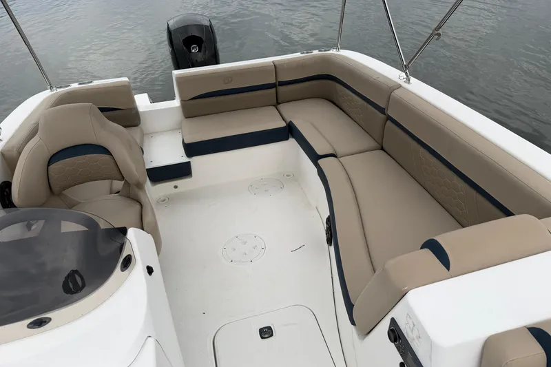 Slide: The Image of 2021 Hurricane SunDeck Sport 192 RL OB boat interior with beige seating and outboard motor. - 10