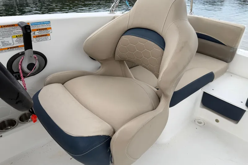 Slide: The Image of 2021 Hurricane SunDeck Sport 192 RL OB boat interior seating with steering wheel. - 11
