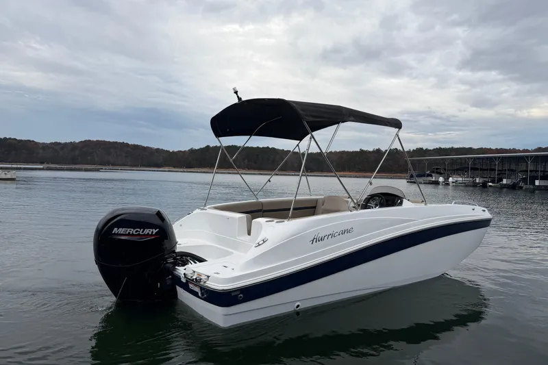Slide: The Image of 2021 Hurricane SunDeck Sport 192 RL OB boat on calm water with Mercury outboard. - 2