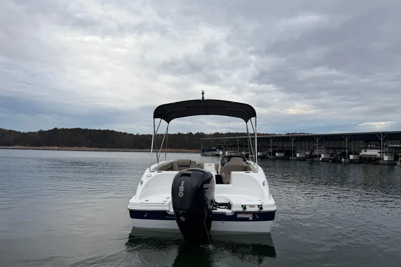 Slide: The Image of 2021 Hurricane SunDeck Sport 192 RL OB boat on calm water under cloudy sky. - 3