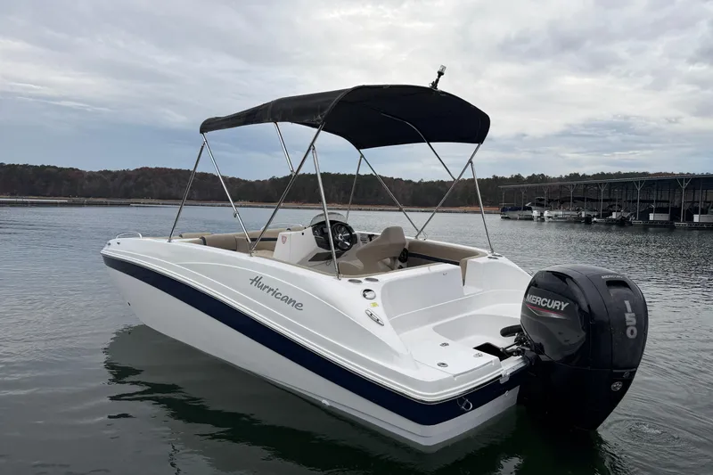 Slide: The Image of 2021 Hurricane SunDeck Sport 192 RL OB boat with Mercury 150 engine on calm water. - 4