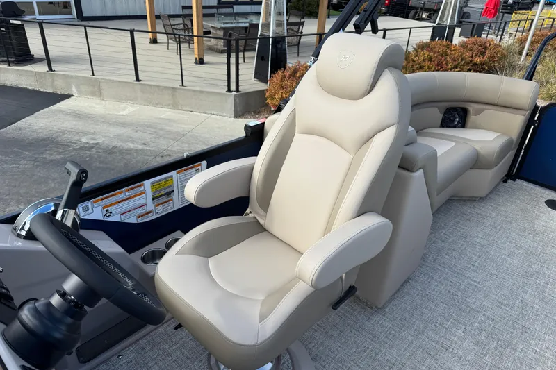 Slide: The Image of Luxurious seating on 2026 Premier 230 SunSation RF pontoon boat, featuring plush captain's chair. - 18