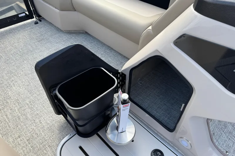 Slide: The Image of Interior of 2026 Premier 230 SunSation RF boat with storage compartment and trash bin. - 22