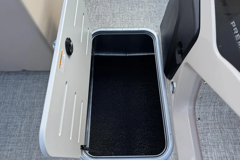 Slide: The Image of Open storage compartment on 2026 Premier 230 SunSation RF boat, featuring sleek design. - 24