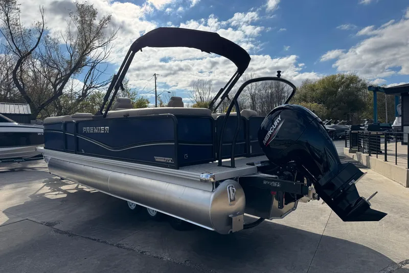 Slide: The Image of 2026 Premier 230 SunSation RF pontoon boat with Mercury outboard motor, parked outdoors. - 4