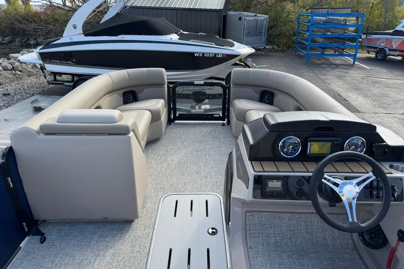 Slide: The Image of 2026 Premier 230 SunSation RF pontoon boat interior with plush seating and modern dashboard. - 8