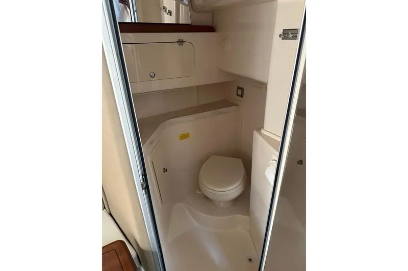 Slide: The Image of 2017 Grady-White Express 330 boat bathroom interior with compact design and storage. - 10