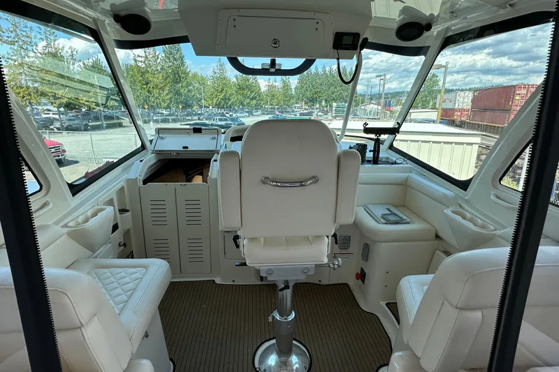 Slide: The Image of 2017 Grady-White Express 330 boat interior with white seating and helm station. - 16