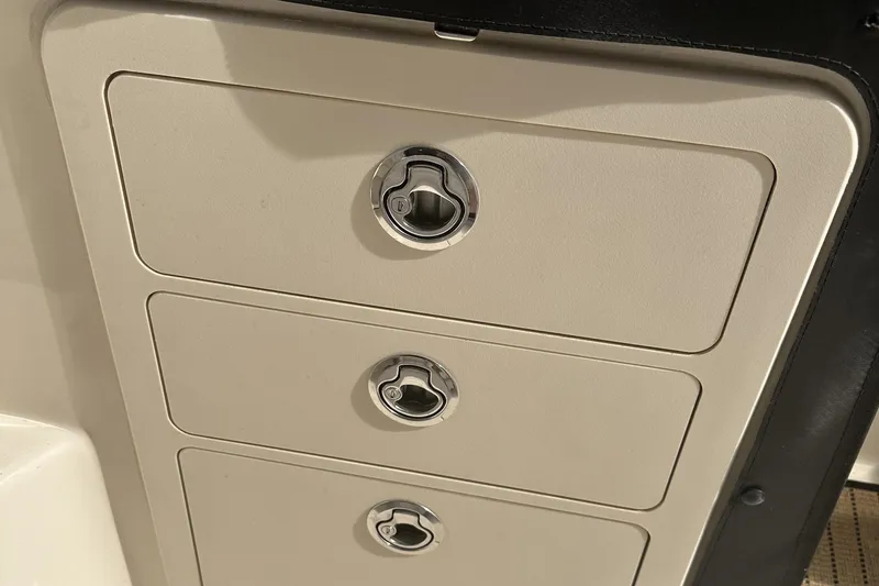 Slide: The Image of 2017 Grady-White Express 330 boat storage compartments with chrome handles. - 18