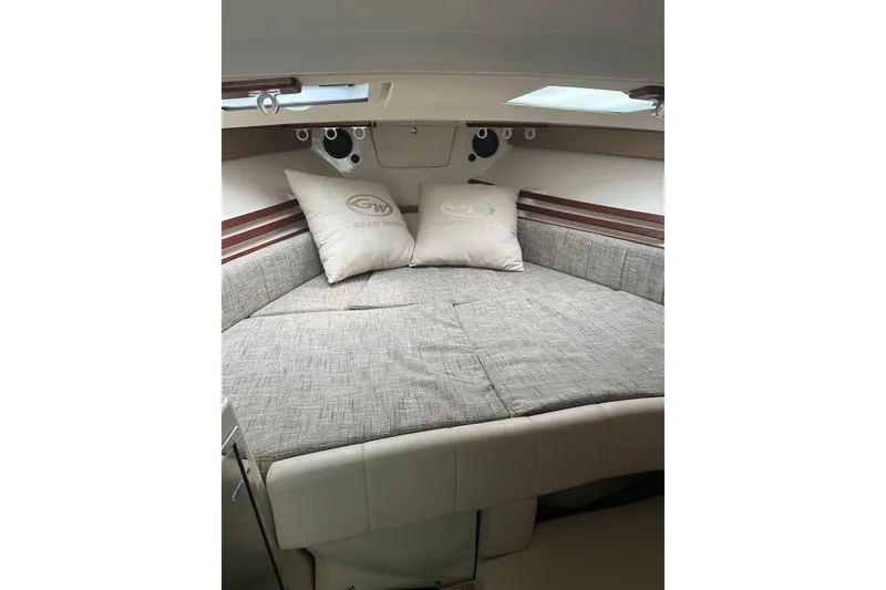 Slide: The Image of 2017 Grady-White Express 330 cabin interior with cozy bedding and pillows. - 19