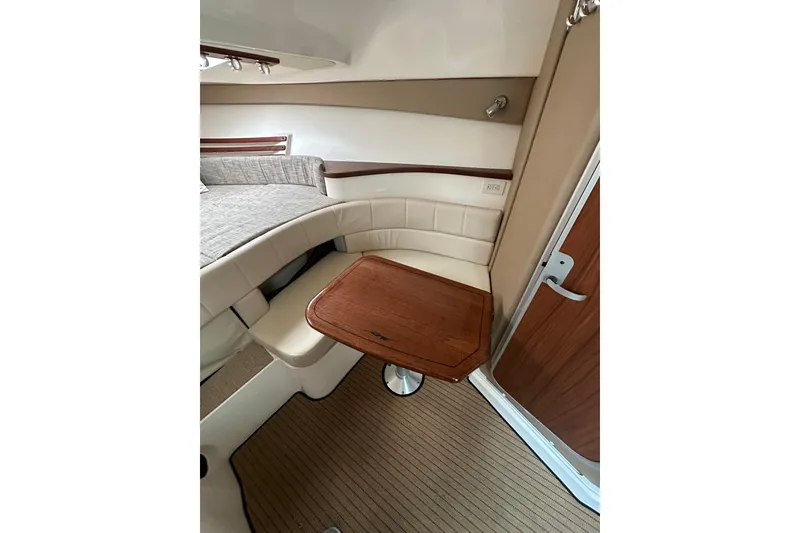 Slide: The Image of 2017 Grady-White Express 330 cabin interior with seating and wooden table. - 20