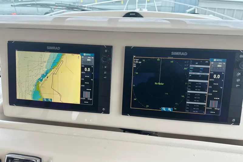 Slide: The Image of Simrad navigation displays on 2017 Grady-White Express 330 boat dashboard. - 24