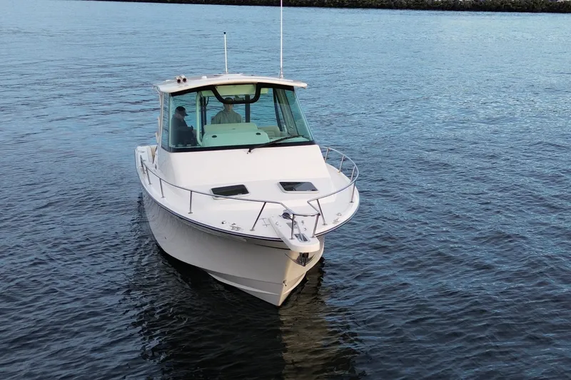 Slide: The Image of 2017 Grady-White Express 330 boat cruising on calm blue waters. - 3