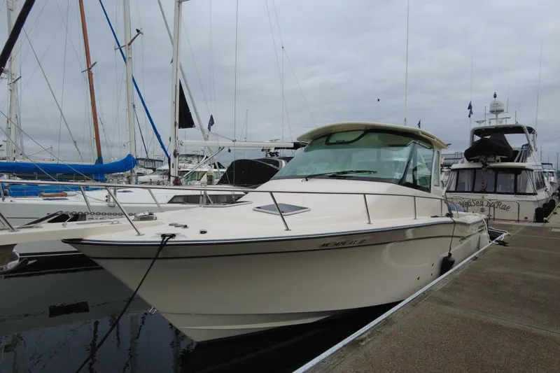 Slide: The Image of 2017 Grady-White Express 330 boat docked at marina, overcast sky. - 4
