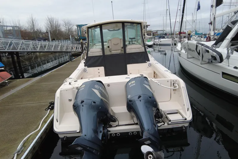 Slide: The Image of 2017 Grady-White Express 330 boat with twin Yamaha V8 engines docked at marina. - 7