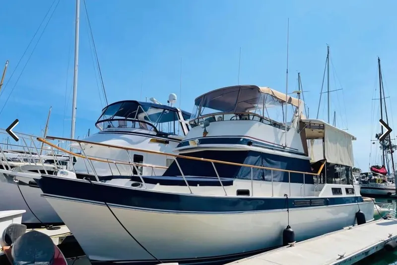 The Image of 1987 Californian 43 Cockpit MY yacht docked at marina under clear blue sky. - 1