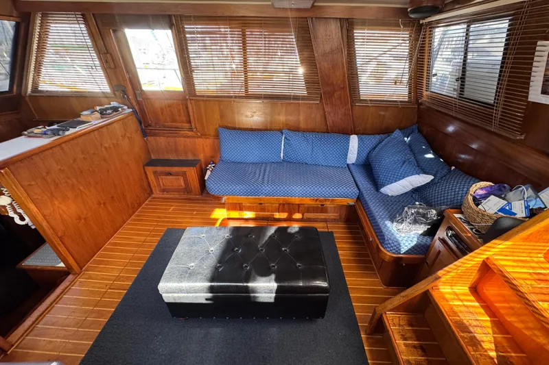 Slide: The Image of Interior of 1987 Californian 43 Cockpit MY with wooden paneling and blue cushioned seating. - 10