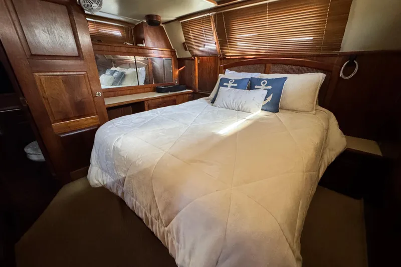 Slide: The Image of Cozy bedroom in 1987 Californian 43 Cockpit MY yacht with nautical-themed decor. - 17