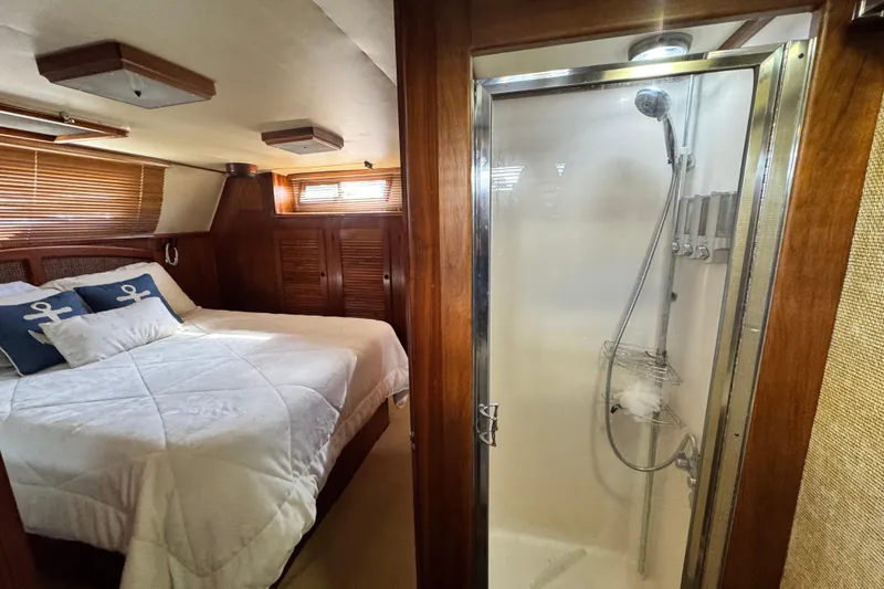 Slide: The Image of 1987 Californian 43 Cockpit MY bedroom with cozy bed and modern shower. - 19