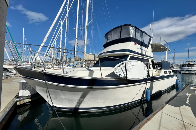 Slide: The Image of 1987 Californian 43 Cockpit MY yacht docked at marina under clear blue sky. - 2