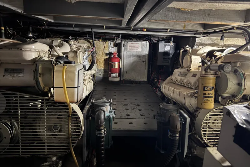 Slide: The Image of Engine room of 1987 Californian 43 Cockpit MY yacht, featuring dual engines and fire extinguisher. - 22