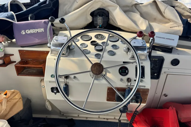 Slide: The Image of 1987 Californian 43 Cockpit MY helm with steering wheel, gauges, and navigation equipment. - 6