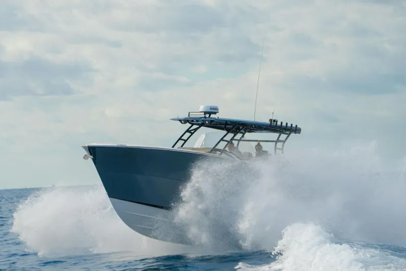 Slide: The Image of 2025 SeaWell 345XL boat navigating through ocean waves under a cloudy sky. - 15